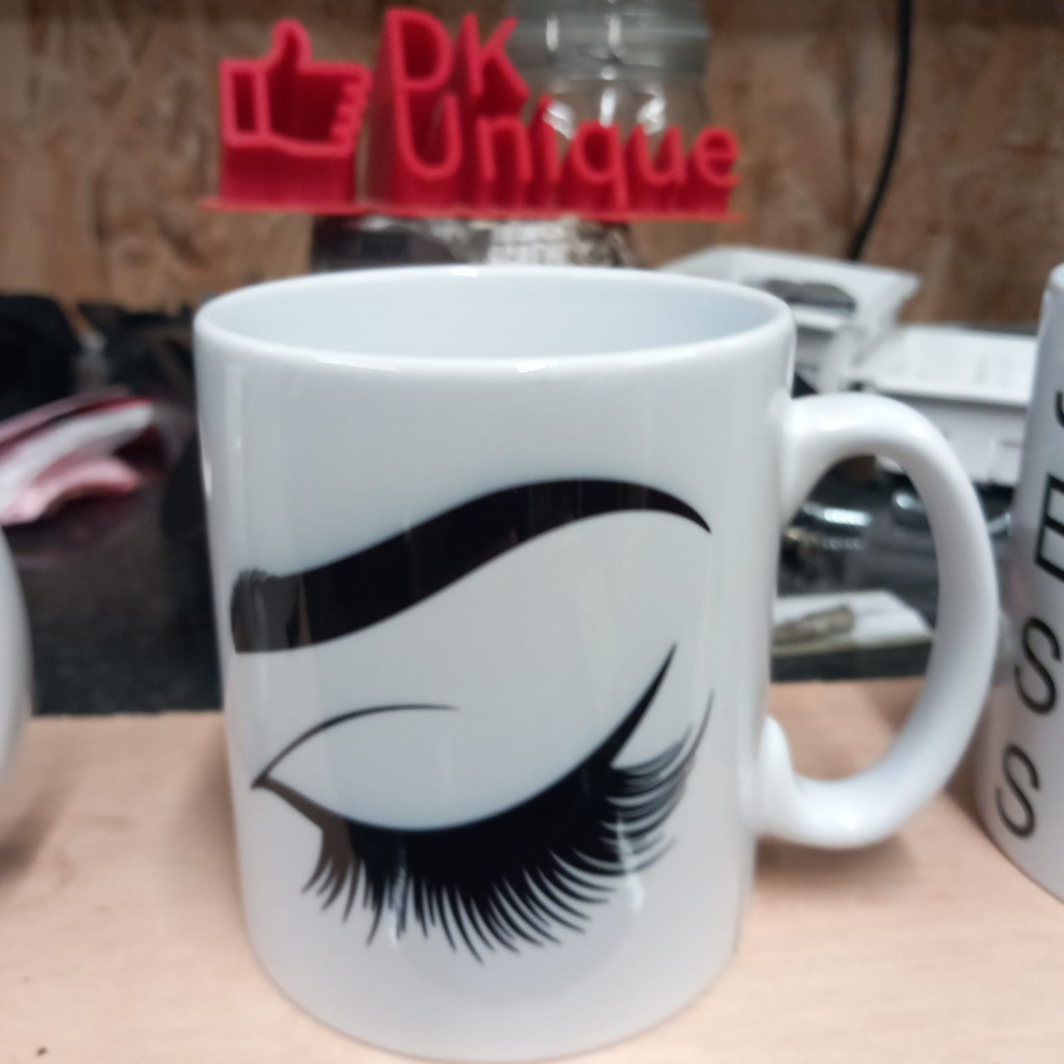 White mug decorated with a black eyelash design