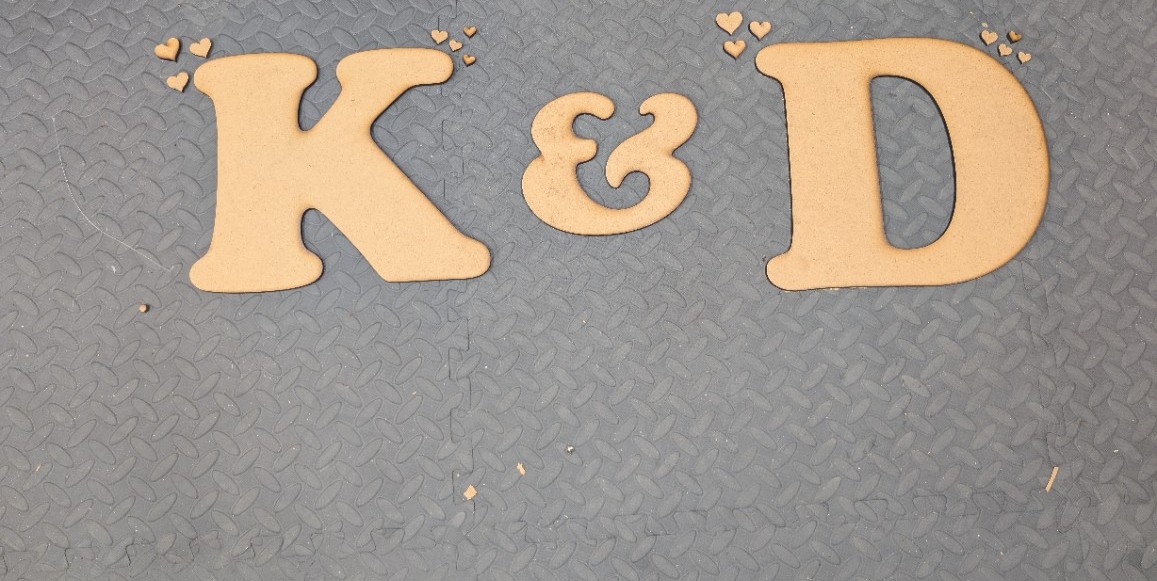 Laser-cut K and D initials