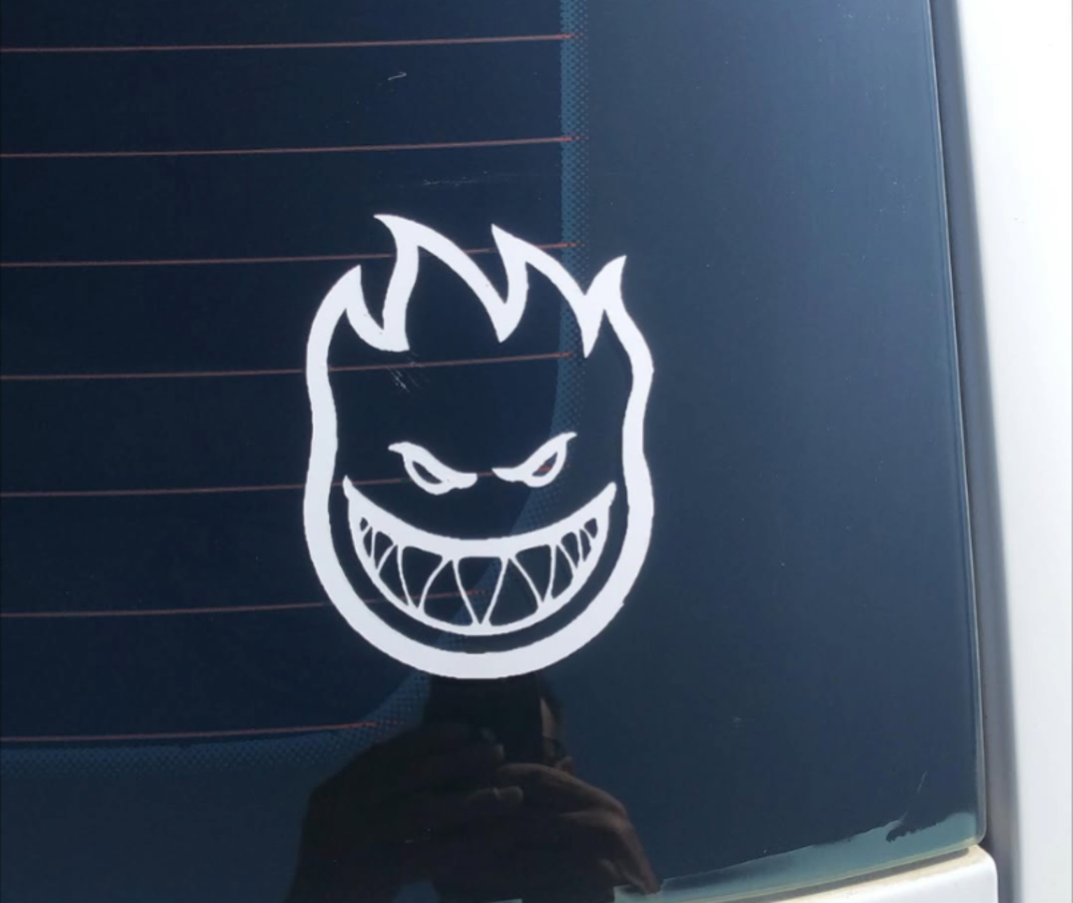 White character vinyl decal on a vehicle rear window