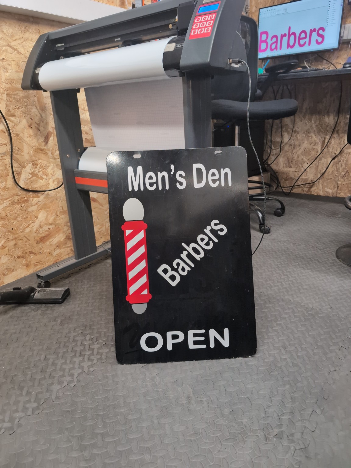 Black Men's Den barbers open sign with red and white vinyl graphics